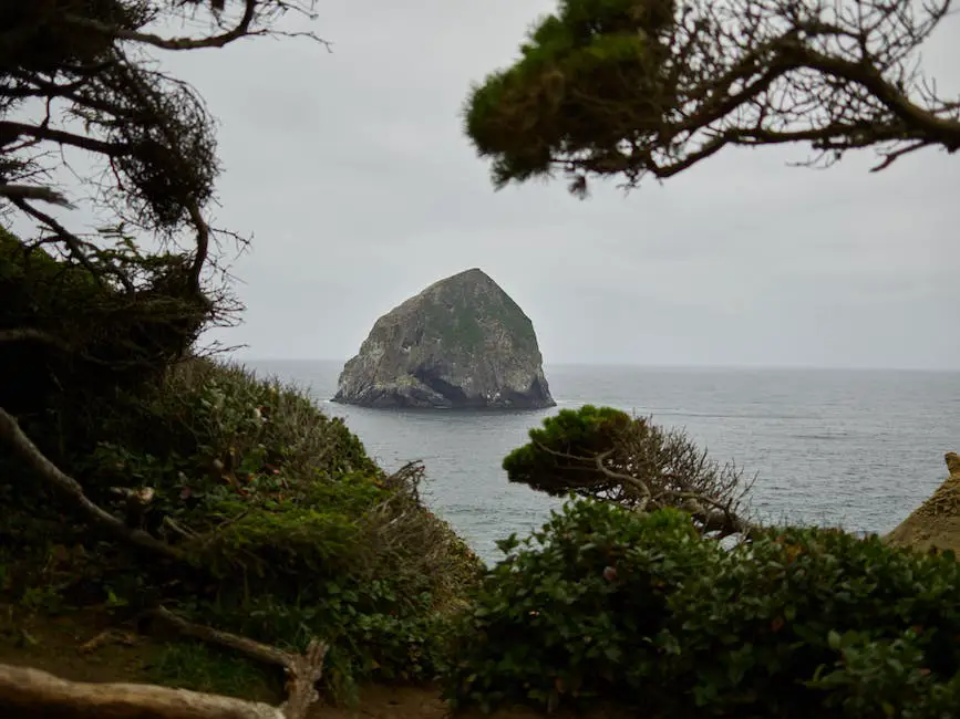 A beautiful coastal view of Portugal with people fishing on the rocks.